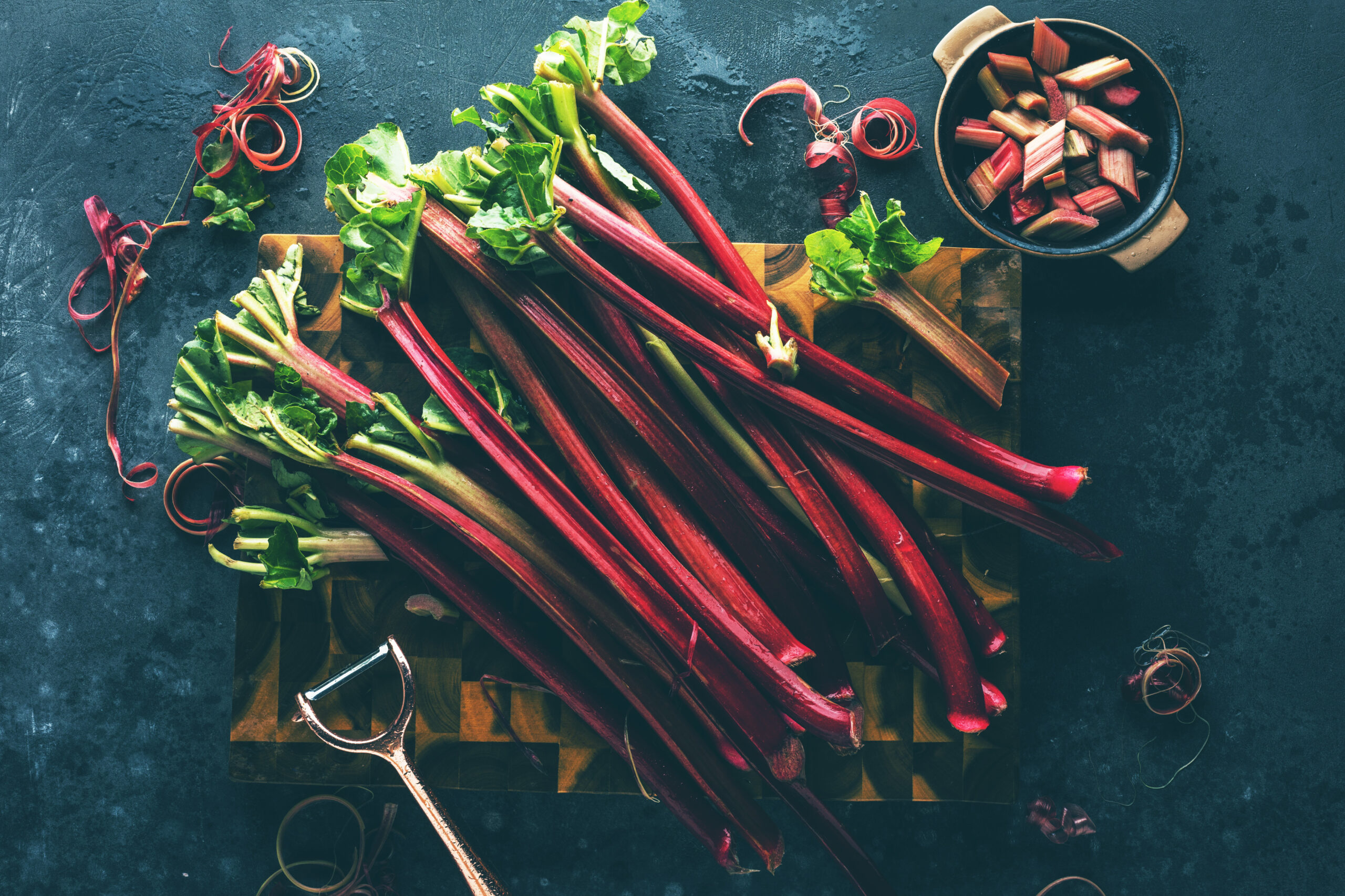 Chopped,Fresh,Rhubarb,On,Dark,Stone,Background.,Top,View.,Free